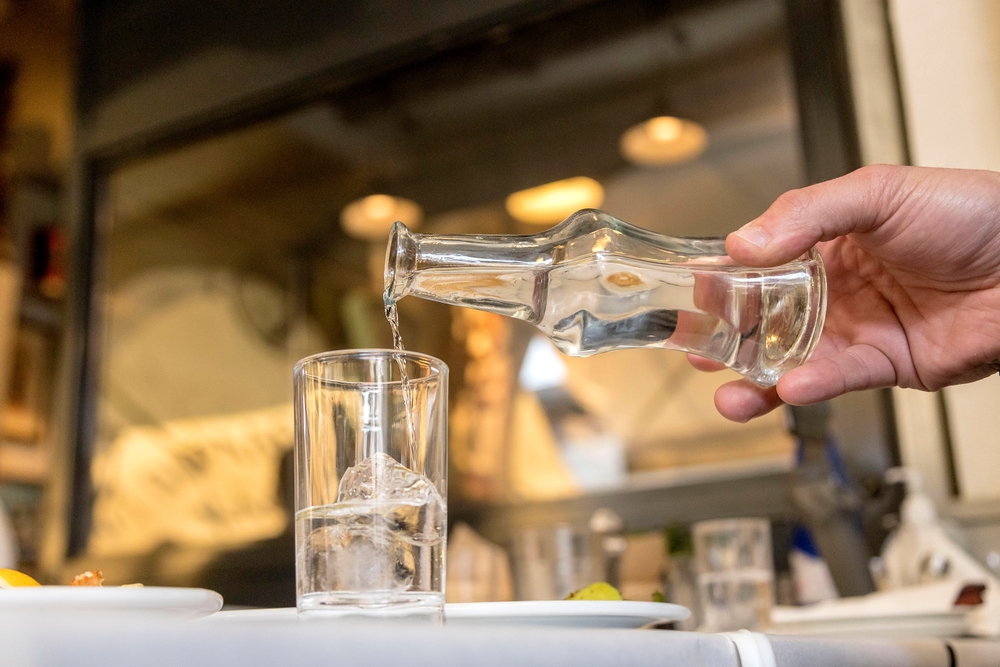 Greek tsipouro being poured into small glass